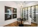 Elegant wine room with a glass-enclosed wine rack and a small dining table at 6644 E Cholla Dr, Paradise Valley, AZ 85253