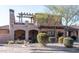 Mediterranean style home with stone accents, a pergola, and a balcony at 7701 E Golden Eagle E Cir, Gold Canyon, AZ 85118