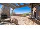 Stone patio with pergola, fireplace, and view at 7701 E Golden Eagle E Cir, Gold Canyon, AZ 85118