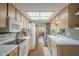 View of kitchen with white appliances and wood cabinets at 7950 E Keats Ave # 170, Mesa, AZ 85209