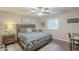 Spacious bedroom with a wooden bed frame and ceiling fan at 7950 E Keats Ave # 170, Mesa, AZ 85209