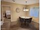 Small dining area with four chairs, adjacent to bedroom and kitchen at 8020 E Keats Ave # 314, Mesa, AZ 85209