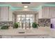 Kitchen with white cabinets, double sink, and decorative backsplash at 8021 W Charter Oak Rd, Peoria, AZ 85381