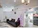 Bright living room with vaulted ceilings, grey sofas, and a view into the kitchen at 8021 W Charter Oak Rd, Peoria, AZ 85381