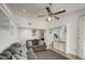 Living room with grey sofas, a ceiling fan and open concept to kitchen at 8021 W Charter Oak Rd, Peoria, AZ 85381