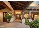 Elegant entryway with a rustic wooden door and tiled flooring at 8408 E La Senda Dr, Scottsdale, AZ 85255