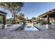 Long rectangular pool with brick coping and water features at 8408 E La Senda Dr, Scottsdale, AZ 85255