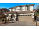 Two-story house with tan exterior, arched entry, and basketball hoop at 904 E Zesta Ln, Gilbert, AZ 85297