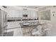 Modern kitchen with white cabinets, granite island, and stainless steel appliances at 904 E Zesta Ln, Gilbert, AZ 85297