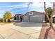 Grey house with three-car garage and driveway at 917 E Betsy Ln, Gilbert, AZ 85296