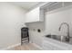 Laundry room with utility sink and cabinets at 917 E Betsy Ln, Gilbert, AZ 85296