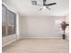 Bright living room with large window and ceiling fan at 917 E Betsy Ln, Gilbert, AZ 85296