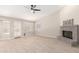 Living room with fireplace and tile flooring, featuring a ceiling fan at 917 E Betsy Ln, Gilbert, AZ 85296