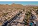 Aerial view of houses and neighborhood with mountains in background at 9345 E Hobart St, Mesa, AZ 85207