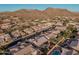 Aerial view showing neighborhood homes, landscaping, and mountain views at 9345 E Hobart St, Mesa, AZ 85207