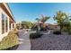 Landscaped backyard with a stone pathway leading to the pool area at 9345 E Hobart St, Mesa, AZ 85207