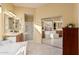 Primary bathroom with double sinks, a large bathtub, and mirrored closet at 9345 E Hobart St, Mesa, AZ 85207