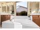 Bathroom with large bathtub, double sinks, and bright window at 9345 E Hobart St, Mesa, AZ 85207