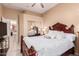 Bedroom with wooden bed frame, mirrored closet, and view of kitchen at 9345 E Hobart St, Mesa, AZ 85207