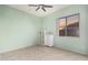 Light green bedroom with tile floors, ceiling fan, and built-in shelving at 9345 E Hobart St, Mesa, AZ 85207