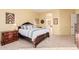 Spacious bedroom with a wooden bed frame, nightstands, and a view of the bathroom at 9345 E Hobart St, Mesa, AZ 85207