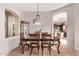 Bright dining room featuring a formal table with seating for six and a view into the kitchen at 9345 E Hobart St, Mesa, AZ 85207