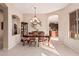 Elegant dining room with chandelier and kitchen views at 9345 E Hobart St, Mesa, AZ 85207