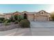 Single-story house with desert landscaping and a two-car garage at 9345 E Hobart St, Mesa, AZ 85207