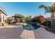 Landscaped backyard with a relaxing pool and patio seating area at 9345 E Hobart St, Mesa, AZ 85207