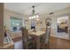 Dining room features a wood table and chairs, and view into living room at 9719 W Pineridge Dr, Sun City, AZ 85351