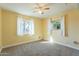 Bright bedroom featuring carpet, ceiling fan, and window at 1019 E Belmont Ave, Phoenix, AZ 85020