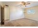 Bedroom with ceiling fan, carpet, and access to another room at 1019 E Belmont Ave, Phoenix, AZ 85020