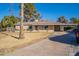 Single story home with palm trees and driveway at 1019 E Belmont Ave, Phoenix, AZ 85020