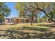 Ranch style home with mature trees and grassy yard at 1019 E Belmont Ave, Phoenix, AZ 85020