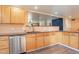 View of kitchen with wood cabinets, granite countertops, and tile floors at 1019 E Belmont Ave, Phoenix, AZ 85020