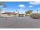 Spacious backyard with gravel landscaping and a covered patio at 10314 W Sun City Blvd, Sun City, AZ 85351