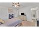 Bright bedroom with ceiling fan and built-in shelving at 10314 W Sun City Blvd, Sun City, AZ 85351