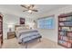 Cozy bedroom with built-in bookcases and ceiling fan at 10314 W Sun City Blvd, Sun City, AZ 85351