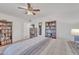 Spacious bedroom with ceiling fan and bookcases at 10314 W Sun City Blvd, Sun City, AZ 85351