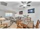 Casual dining space adjacent to living room with wood table and chairs at 10314 W Sun City Blvd, Sun City, AZ 85351