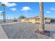 House exterior showcasing desert landscaping and a palm tree at 10314 W Sun City Blvd, Sun City, AZ 85351