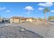 Front view of a single-story house with a long driveway at 10314 W Sun City Blvd, Sun City, AZ 85351