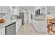 Galley kitchen with granite countertops and white cabinets at 10314 W Sun City Blvd, Sun City, AZ 85351