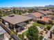 Aerial view of a house with a large backyard, pergola, and mountain views at 10315 E Palladium Dr, Mesa, AZ 85212