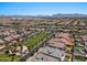 Aerial view of a community with houses, green spaces, and mountain views at 10315 E Palladium Dr, Mesa, AZ 85212