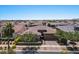 Aerial view of a single story home with a large driveway and mature landscaping at 10315 E Palladium Dr, Mesa, AZ 85212