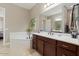 Spa-like bathroom with double vanity and a large soaking tub at 10315 E Palladium Dr, Mesa, AZ 85212