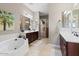 Double vanity bathroom with soaking tub and walk-in shower at 10315 E Palladium Dr, Mesa, AZ 85212