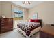 Comfortable bedroom with wood dresser and window at 10315 E Palladium Dr, Mesa, AZ 85212