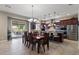 Kitchen and dining area with hardwood table and chairs, open to the living room at 10315 E Palladium Dr, Mesa, AZ 85212